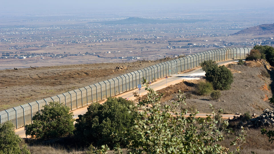 Long fenced border between countries.