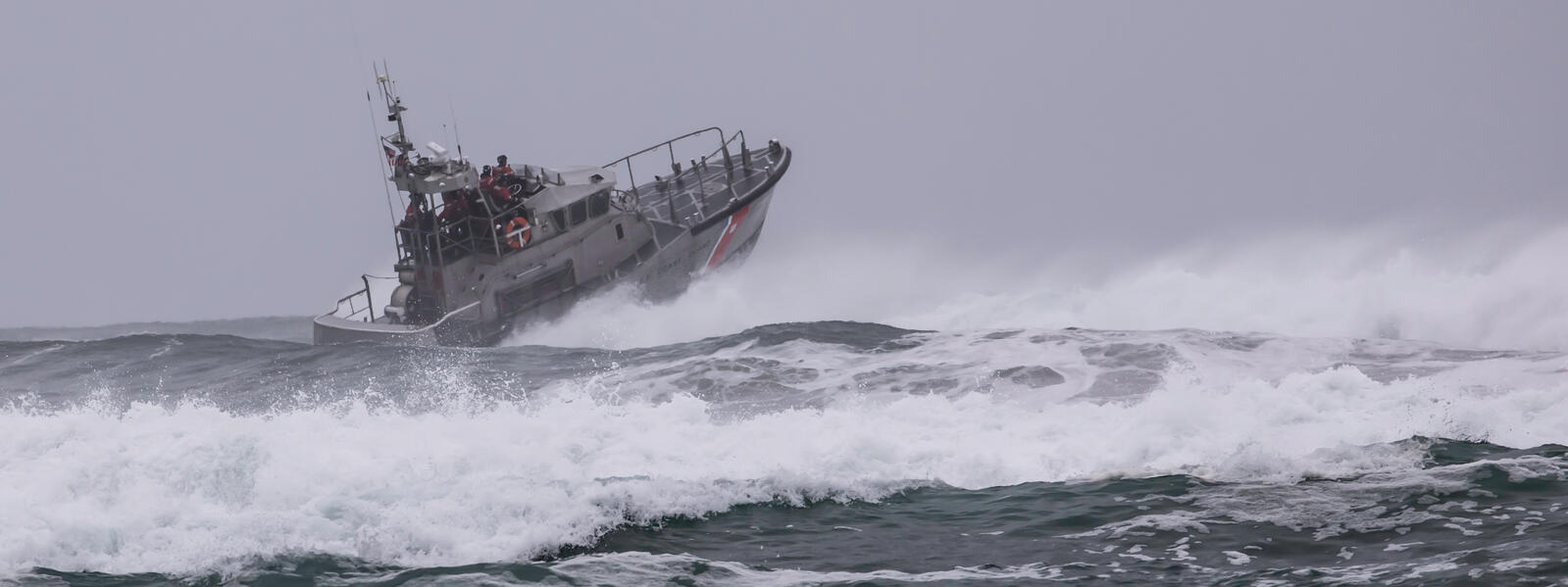 Coast guard vessel in heavy storm conditions.
