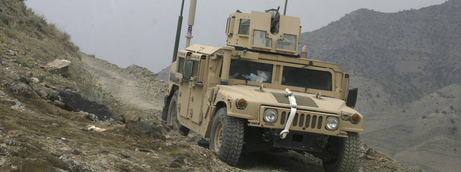 Military vehicle in mountainous terrain.